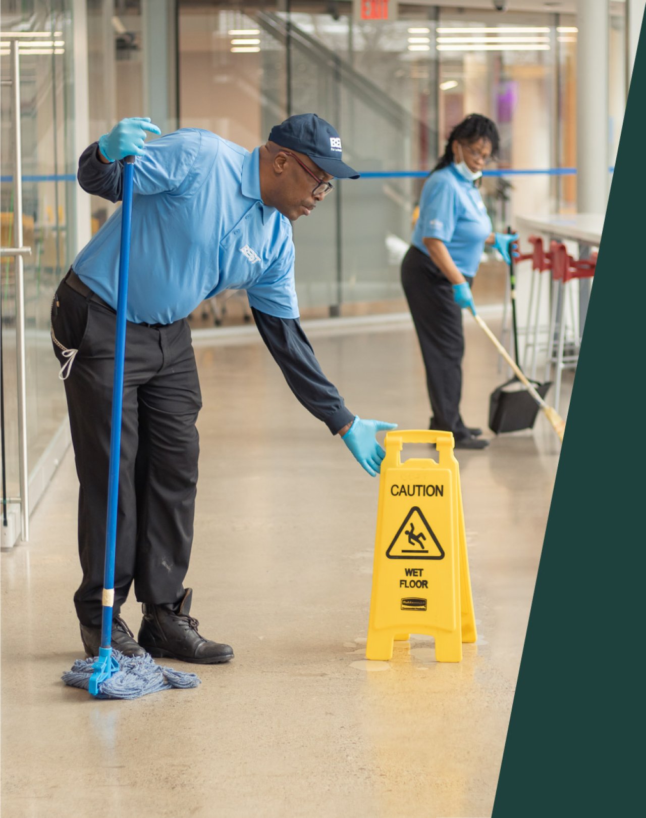 Cleaner placing a caution sign on the floor.