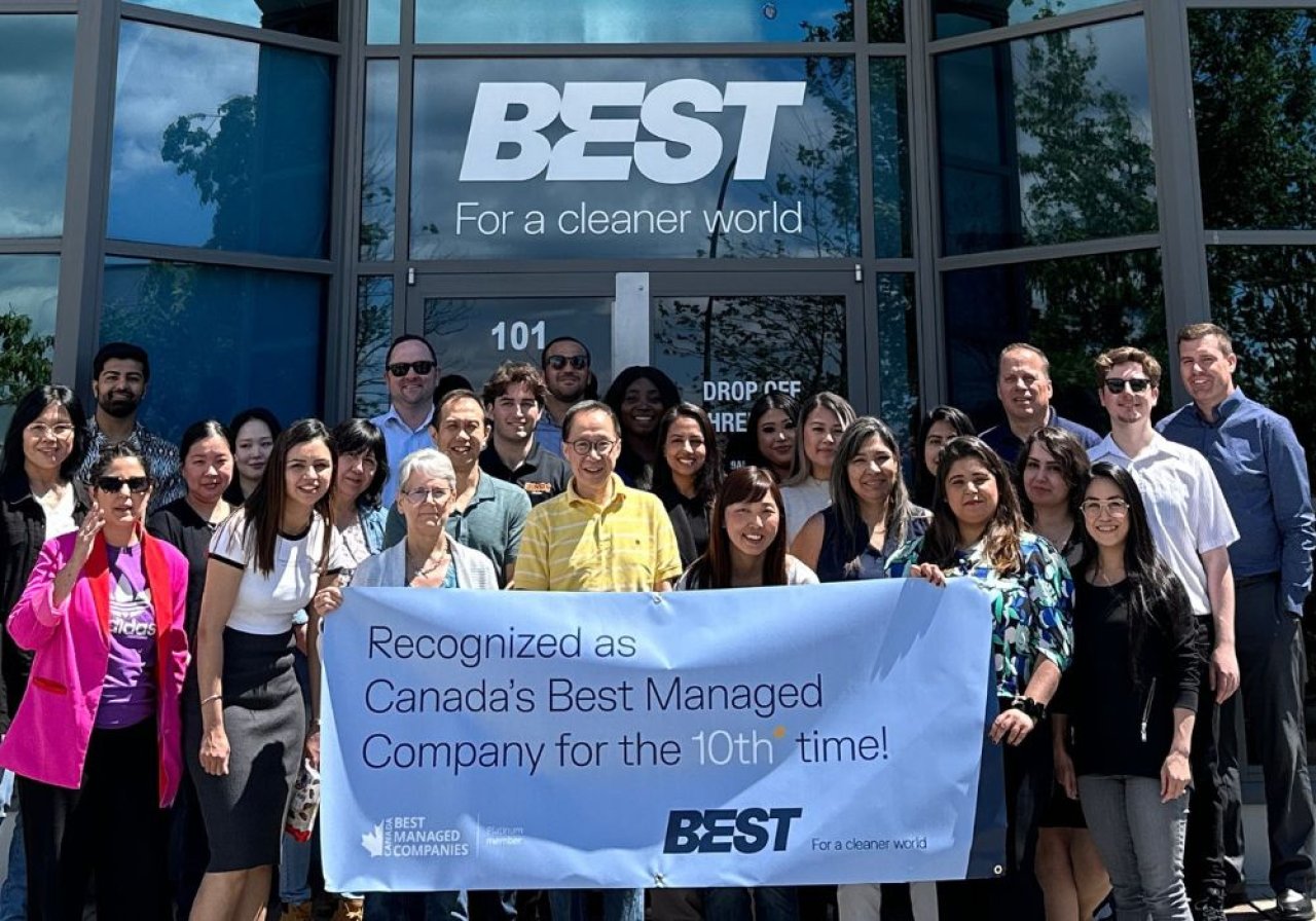 Employees celebrating with a Canada’s Best Managed Company sign.