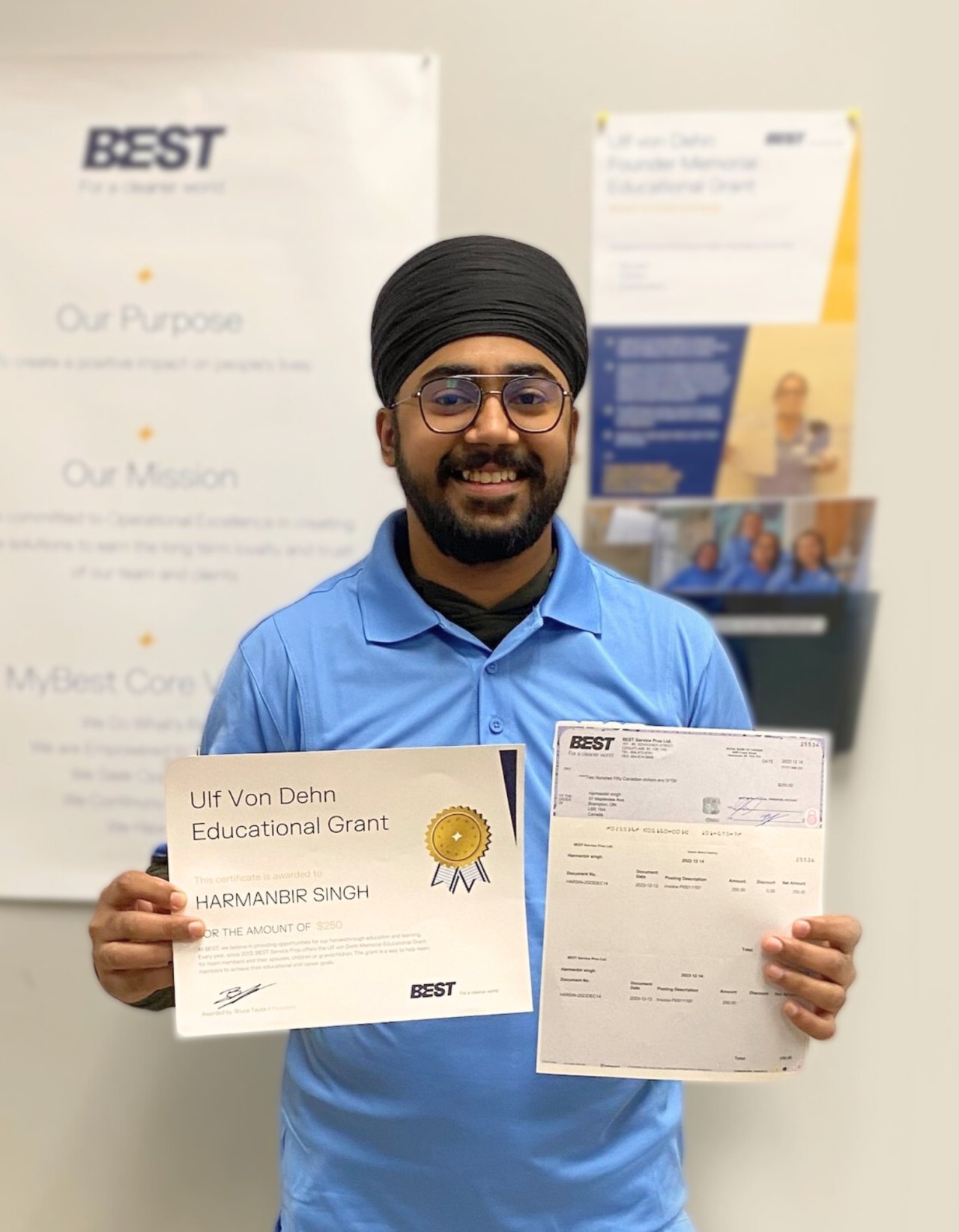 Employee proudly holding a grant certificate.