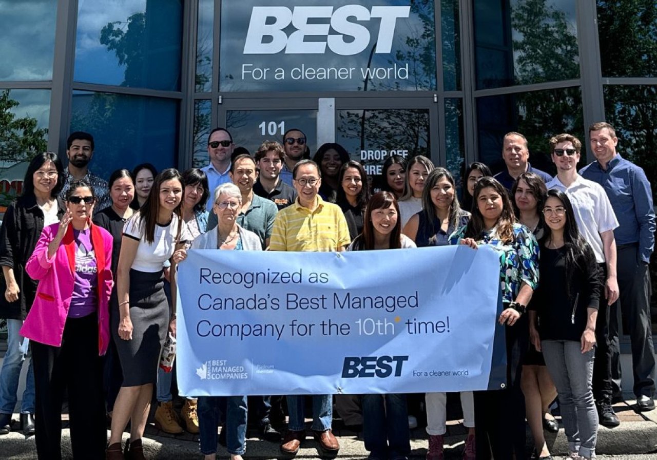 Employees celebrating with a Canada’s Best Managed Company sign.